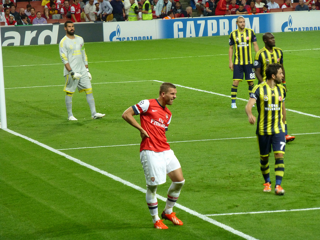 Arsenal's Lukas Podolski feels his hamstring go against Fenerbache in the Champions League - Image by Wonker (Flickr CC)