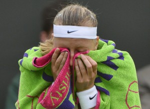 Petra Kvitova of the Czech Republic wipes her face during her women's singles tennis match against Coco Vandeweghe of the U.S. at the Wimbledon Tennis Championships, in London