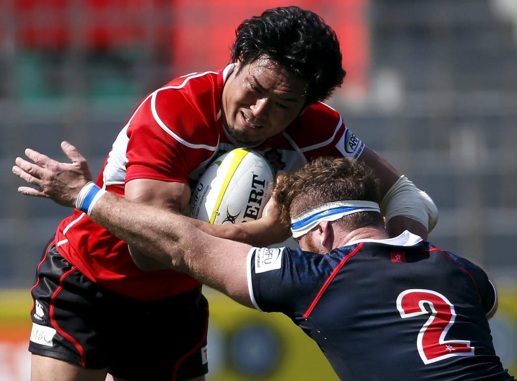 Japan's Ito is tackled by Hong Kong's Harris during their international rugby test match in Tokyo