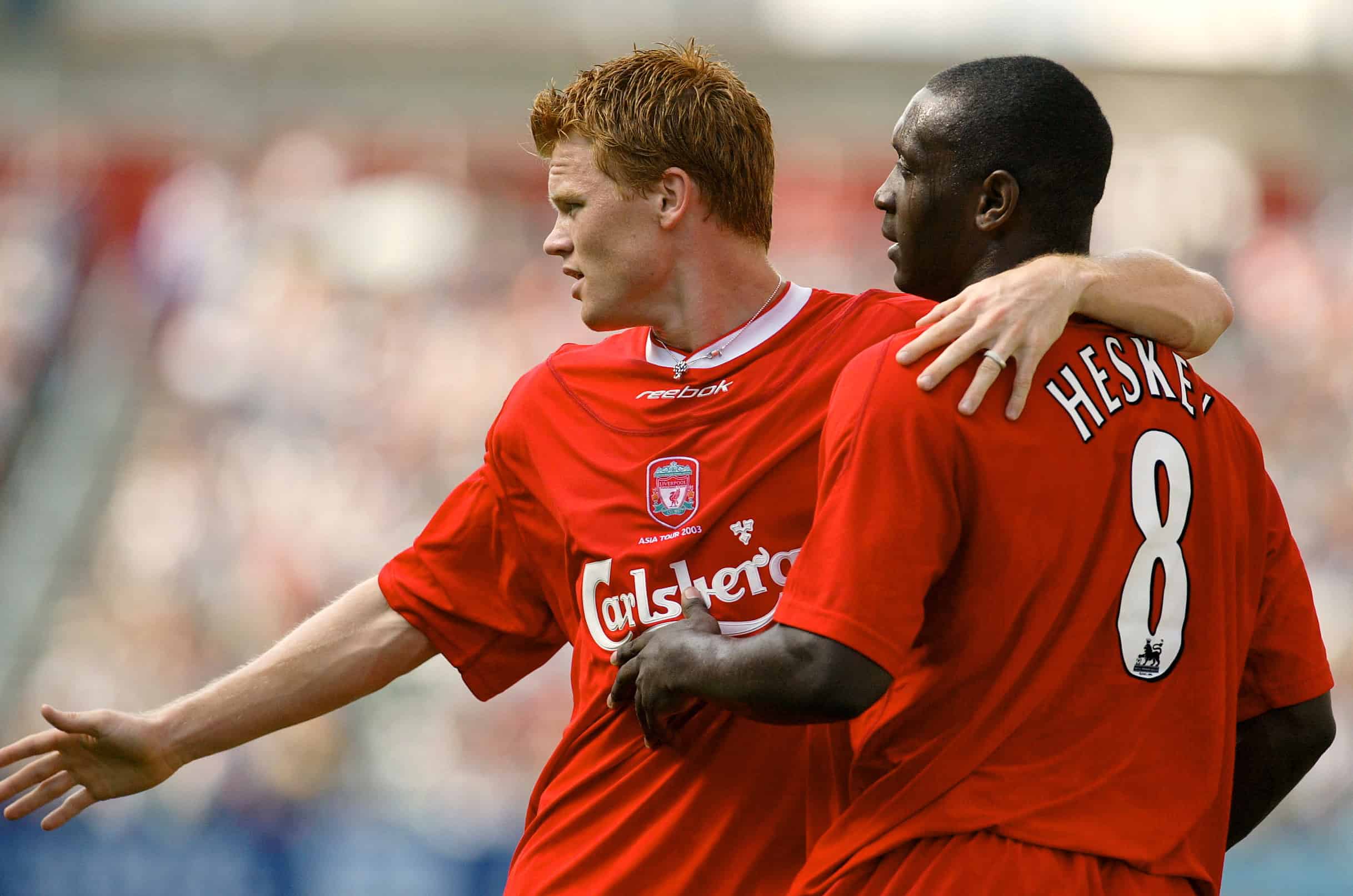 LIVERPOOL'S HESKEY AND RIISE CELEBRATE AFTER SCORING IN HONG KONG.